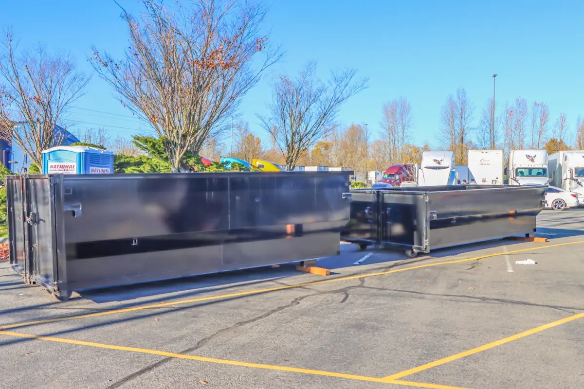 Professional dumpster rental service with roll-off container on residential driveway in Fullerton
